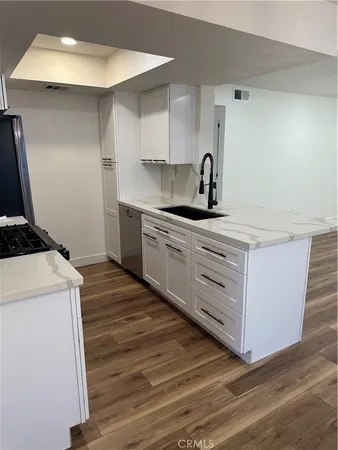 a kitchen with a sink stove and cabinets