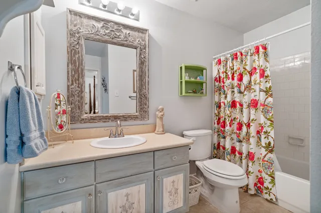 a bathroom with a sink mirror vanity and toilet