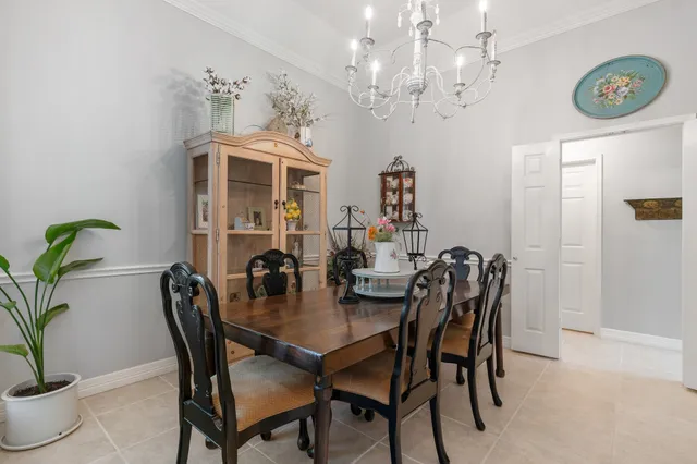 a view of a dining room with furniture and chandelier