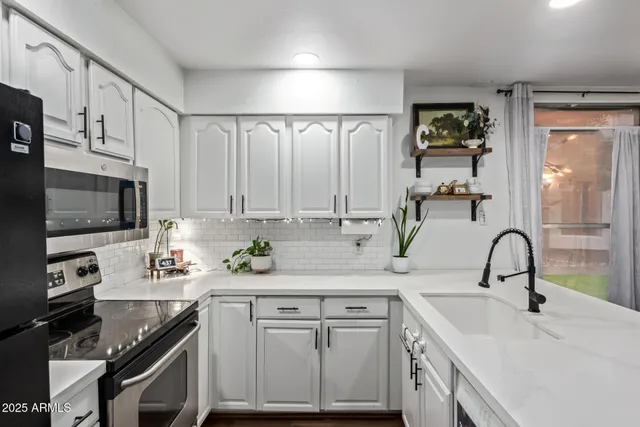 a kitchen with a sink stove and cabinets