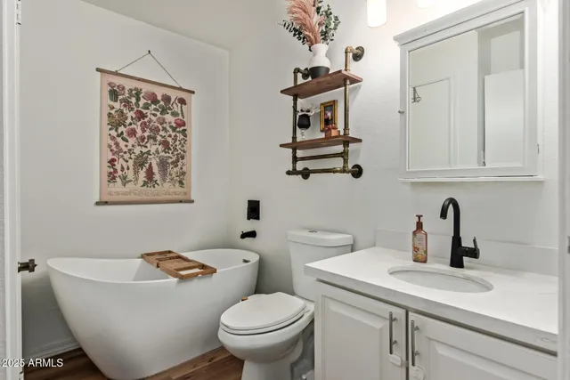a bathroom with a toilet a sink and mirror