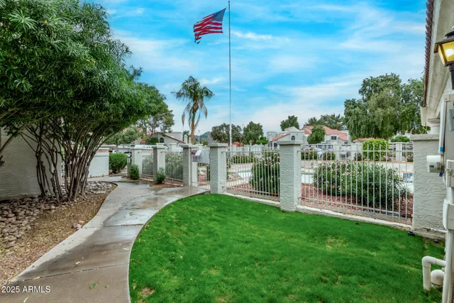 a view of a garden with a building in the background