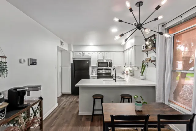 a view of kitchen with cabinets and wooden floor