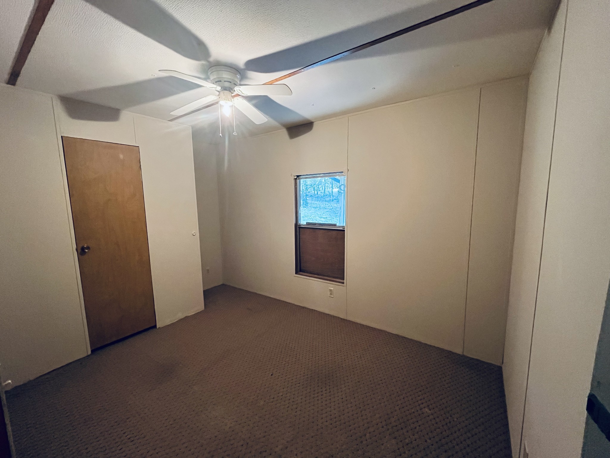 294 Ridgeway Drive Sugar Tree, TN 38380 - Photo 18 of 28 an empty room with windows and fan