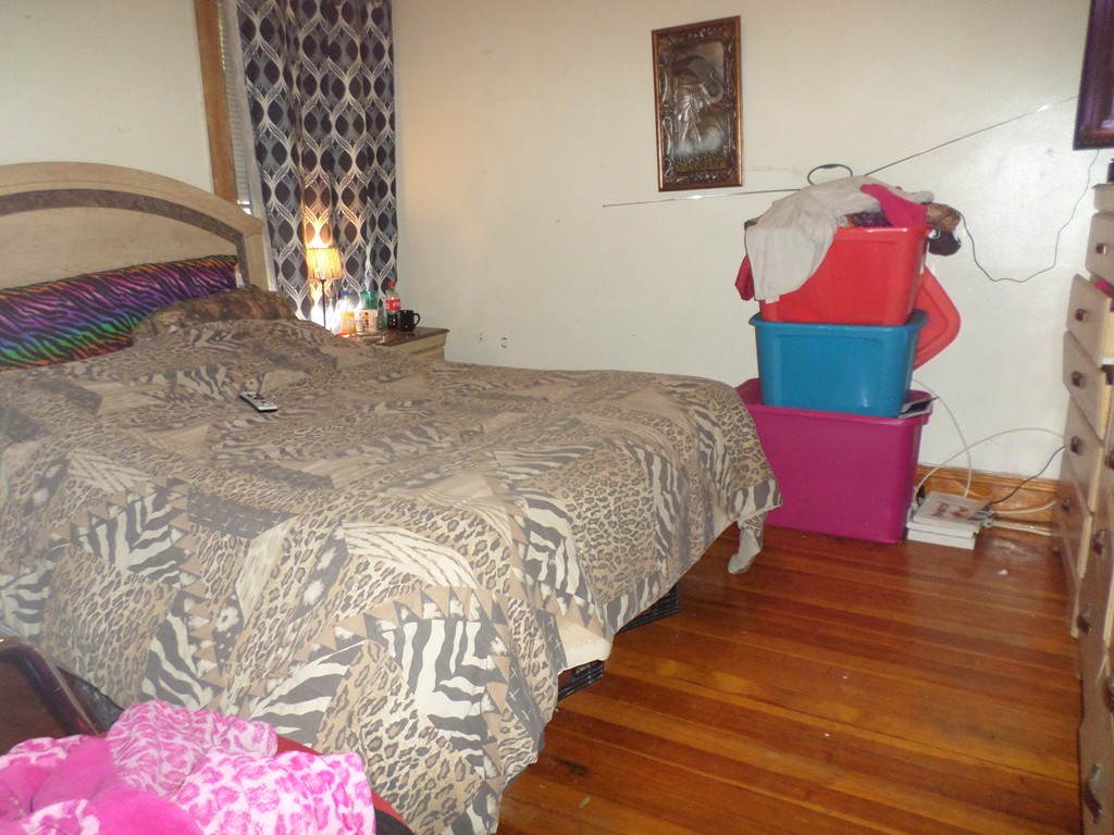 60-62 Merida Street Springfield, MA 01104 - Photo 18 of 22 a bedroom with a bed and a couch