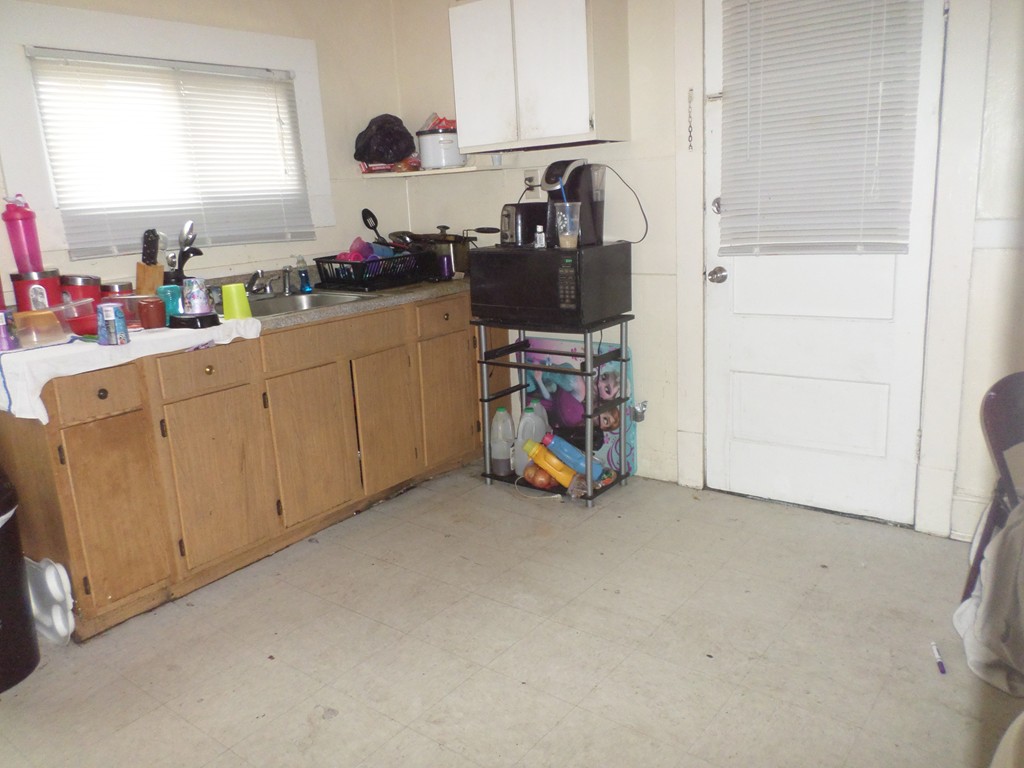 60-62 Merida Street Springfield, MA 01104 - Photo 3 of 22 a view of a kitchen with fridge and workspace