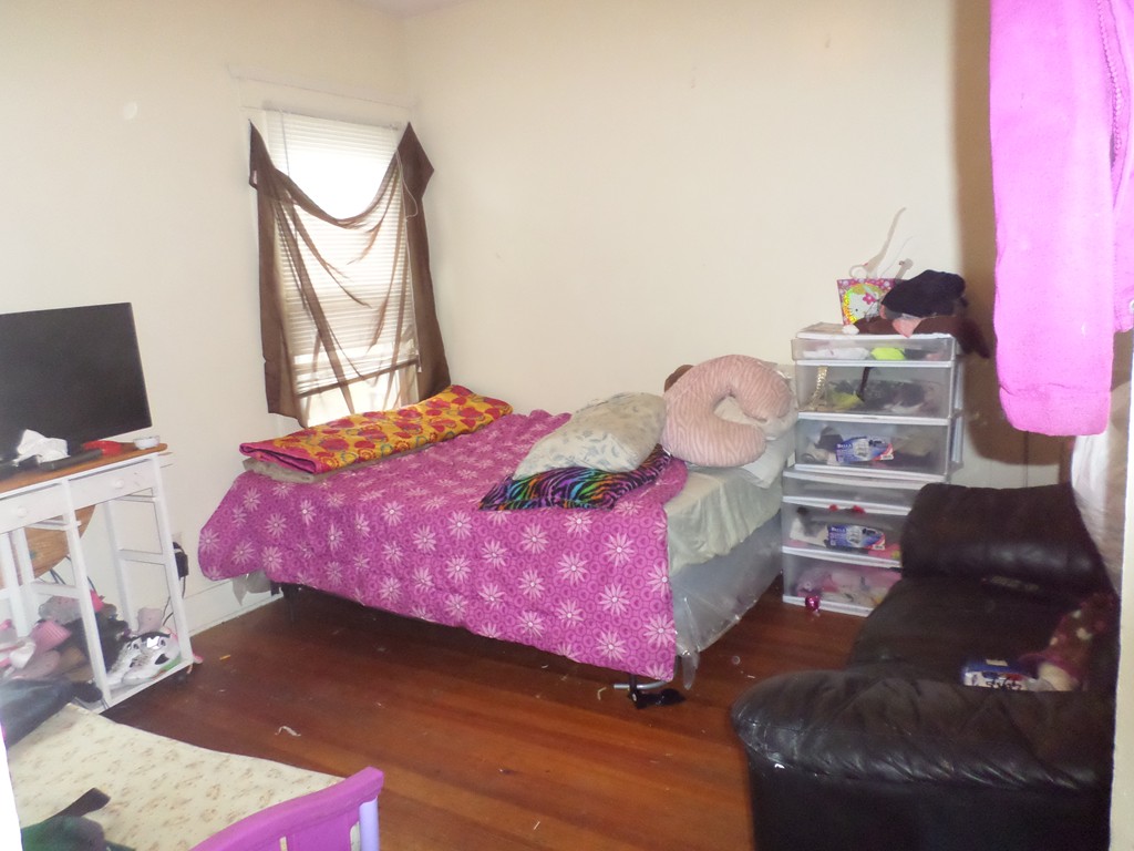 60-62 Merida Street Springfield, MA 01104 - Photo 5 of 22 a bedroom with a bed chair and dresser