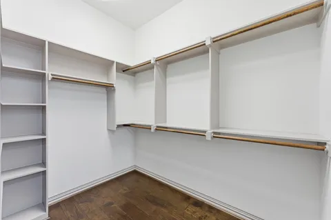 a view of walk in closet with empty racks