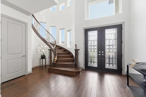 a view of entryway with wooden floor and stairs