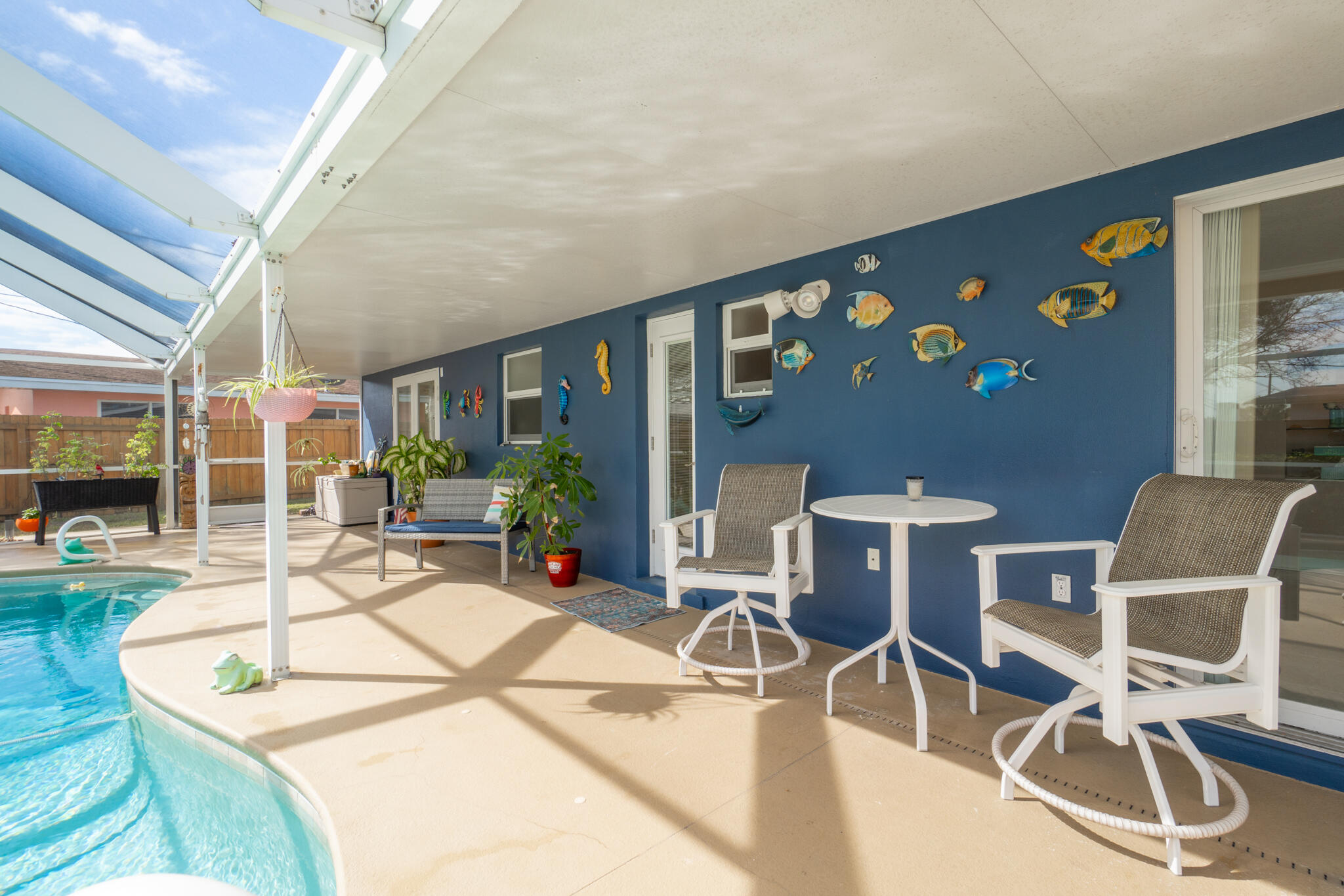 560 Capri Road Cocoa Beach, FL 32931 - Photo 11 of 31 a view of a dining room with furniture and floor to ceiling window