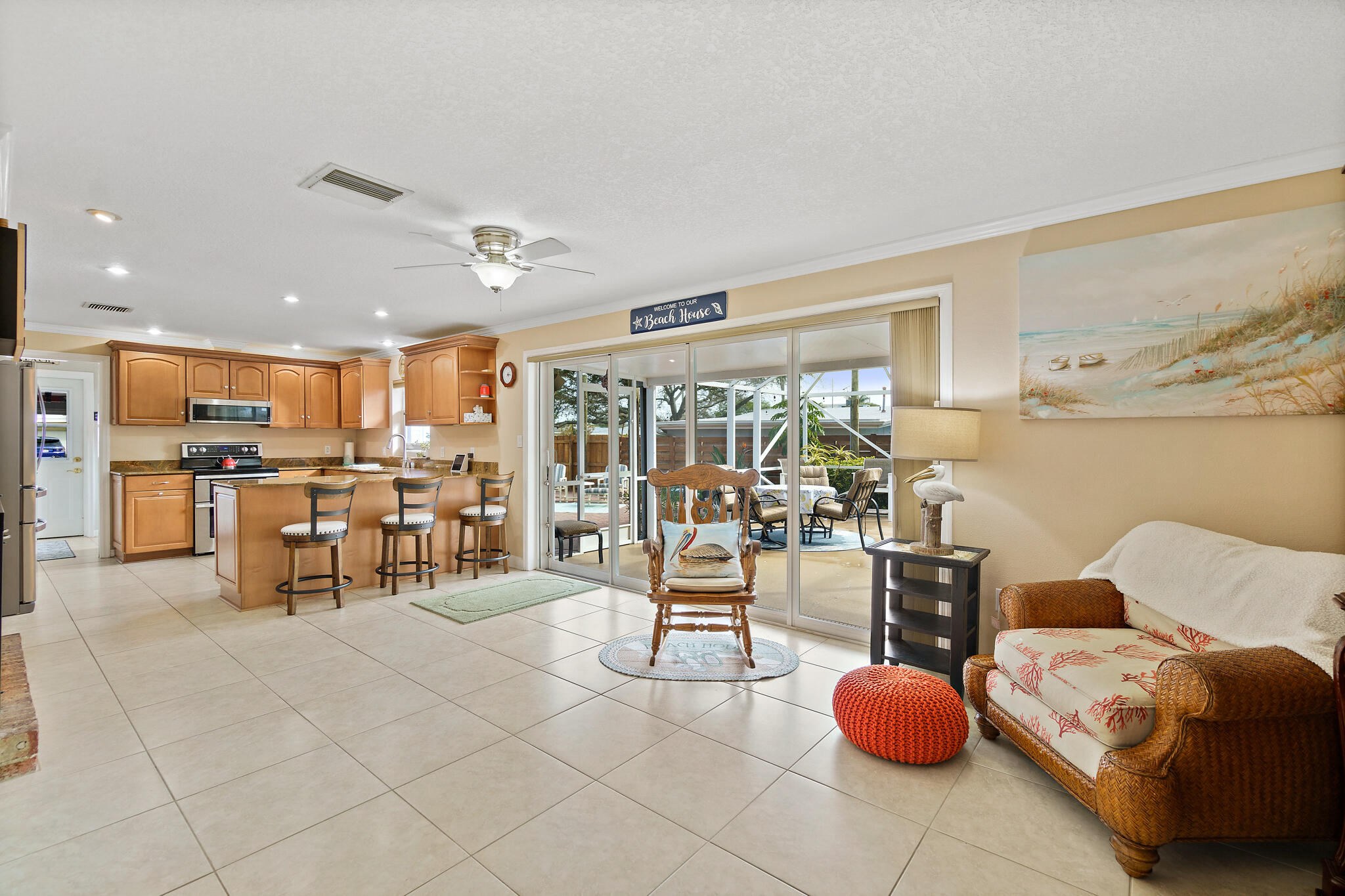 560 Capri Road Cocoa Beach, FL 32931 - Photo 16 of 31 a living room with lots of furniture and chairs
