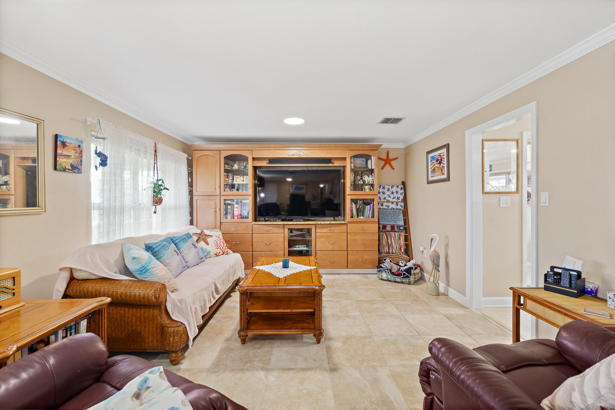 560 Capri Road Cocoa Beach, FL 32931 - Photo 21 of 31 a living room with furniture and a flat screen tv