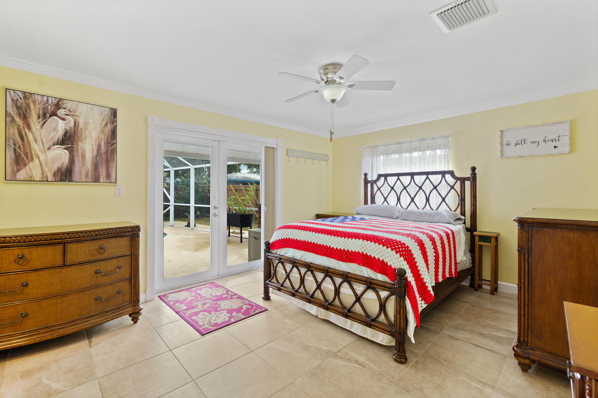 560 Capri Road Cocoa Beach, FL 32931 - Photo 23 of 31 a bedroom with a bed and window