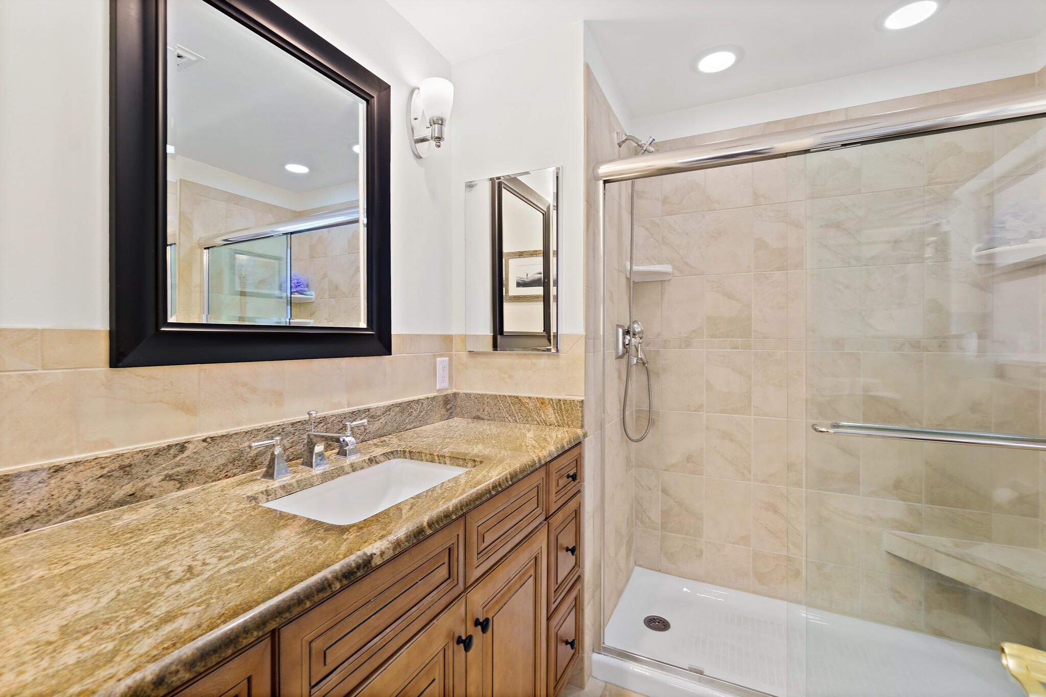 560 Capri Road Cocoa Beach, FL 32931 - Photo 24 of 31 a bathroom with a granite countertop sink a mirror a shower and a bathtub