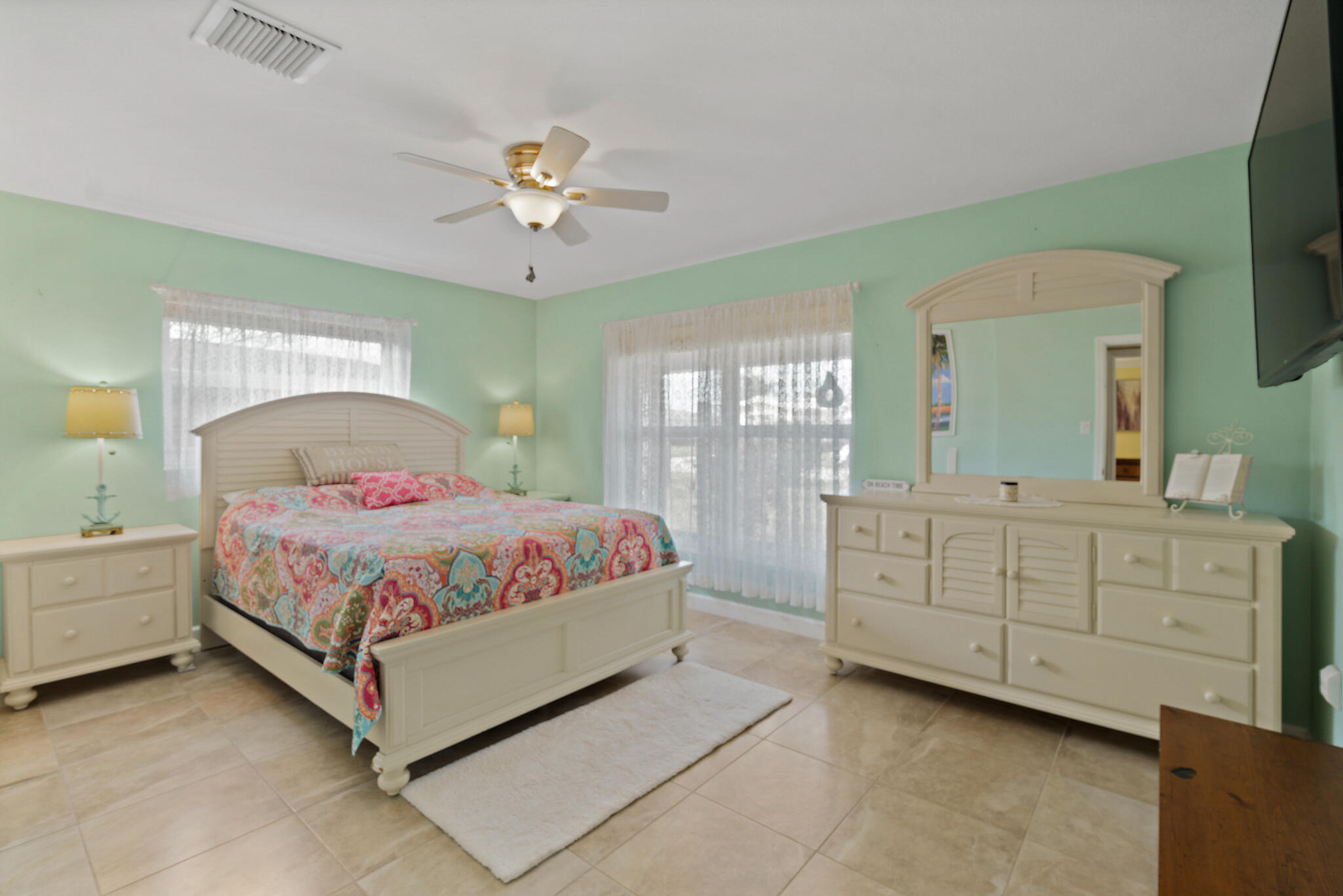 560 Capri Road Cocoa Beach, FL 32931 - Photo 25 of 31 a bedroom with a bed and a dresser