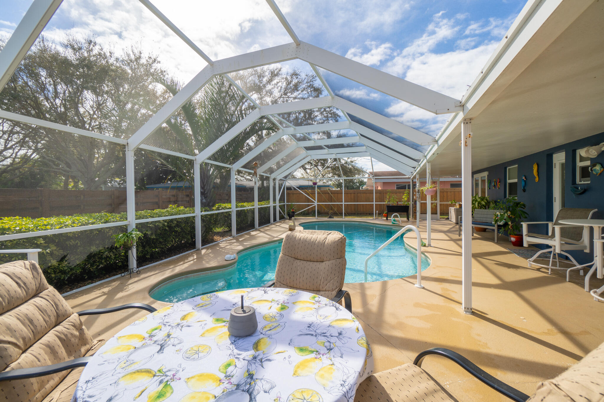 560 Capri Road Cocoa Beach, FL 32931 - Photo 27 of 31 a view of a patio with couches chairs and wooden floor