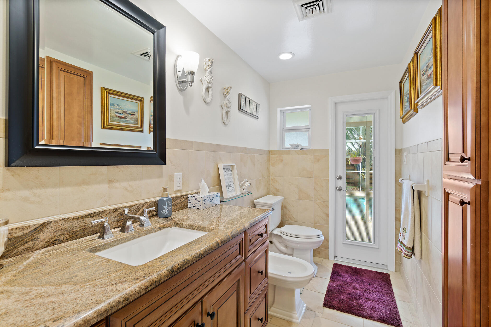 560 Capri Road Cocoa Beach, FL 32931 - Photo 9 of 31 a bathroom with a granite countertop sink toilet and shower