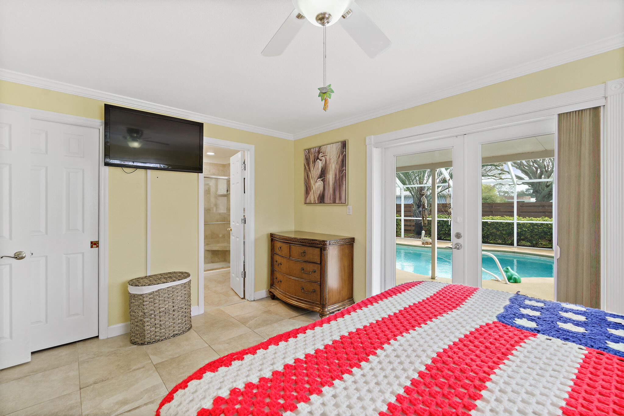 560 Capri Road Cocoa Beach, FL 32931 - Photo 10 of 31 a bedroom with a bed and a couch