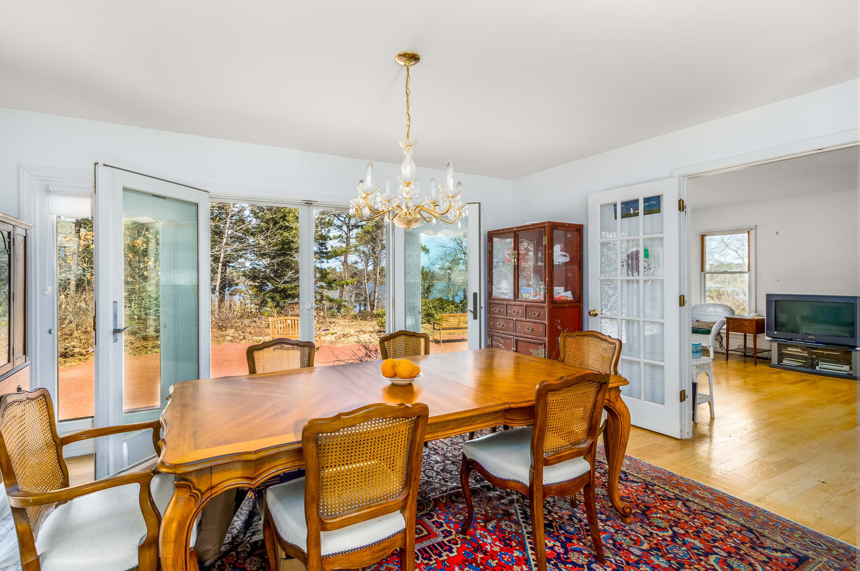 104 Seapine Road North Chatham, MA 02650 - Photo 14 of 36 a dining room with furniture a chandelier and wooden floor