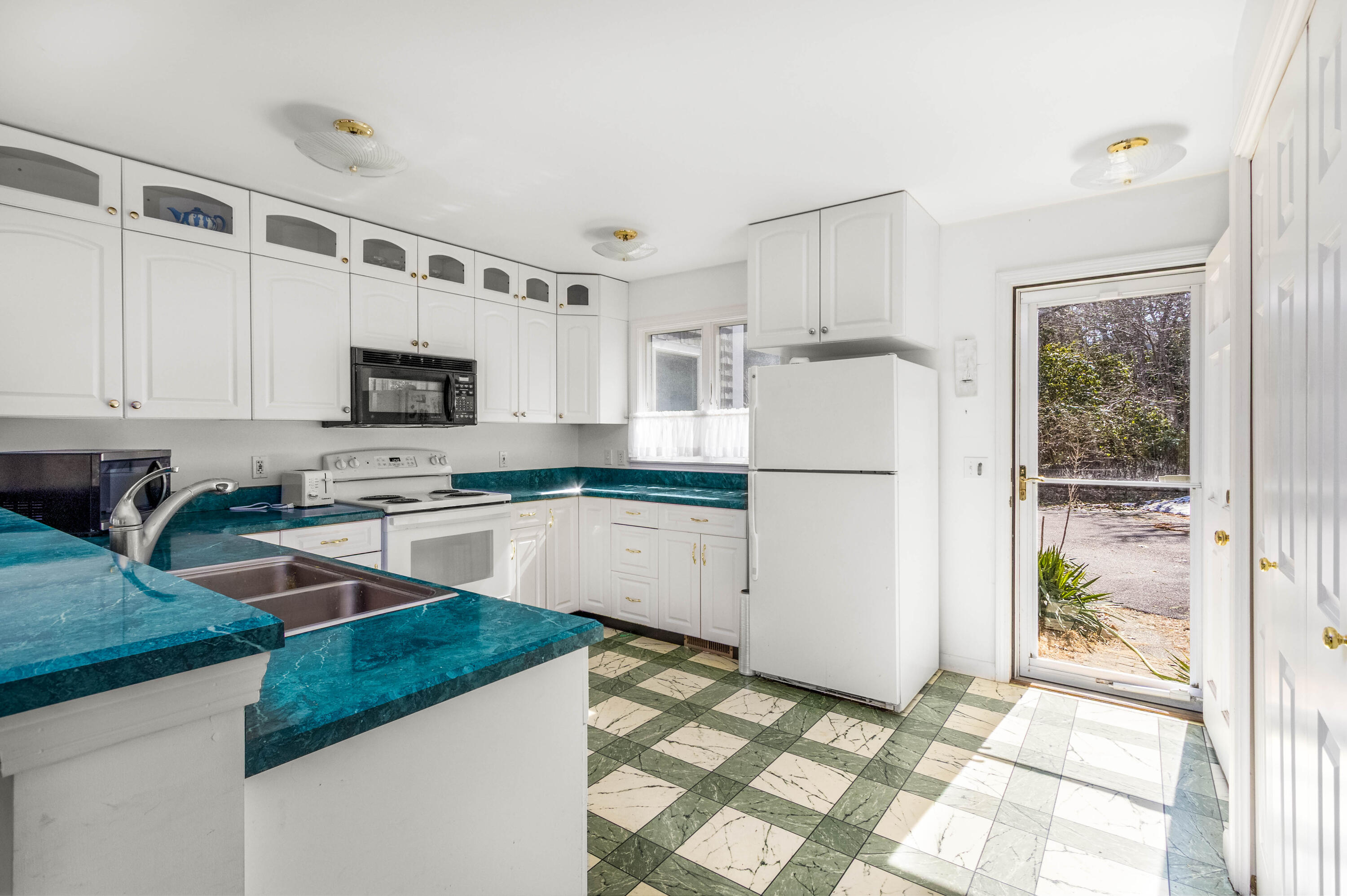 104 Seapine Road North Chatham, MA 02650 - Photo 17 of 36 a kitchen with white cabinets and white appliances