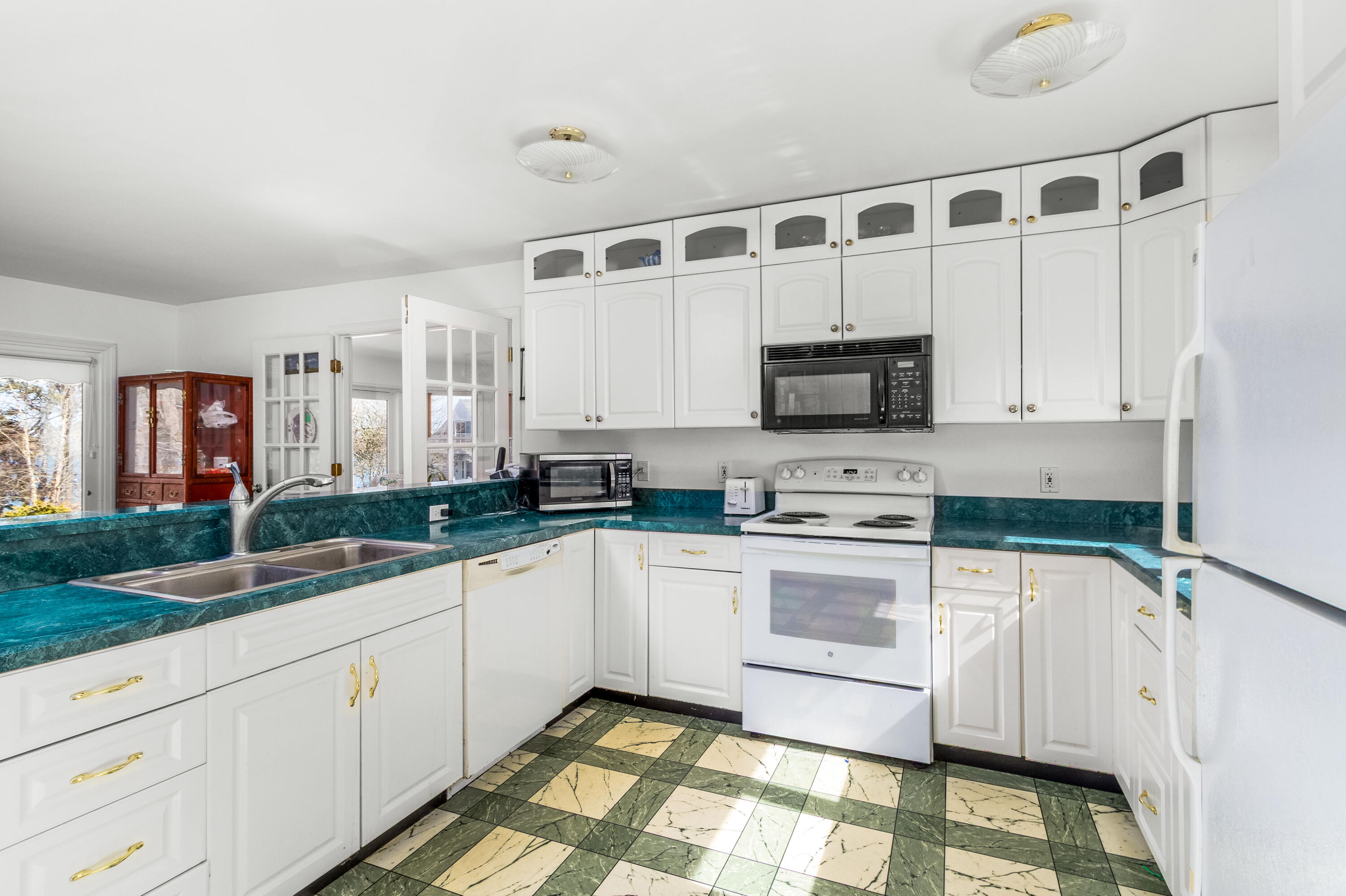 104 Seapine Road North Chatham, MA 02650 - Photo 18 of 36 a kitchen with granite countertop white cabinets and white stainless steel appliances