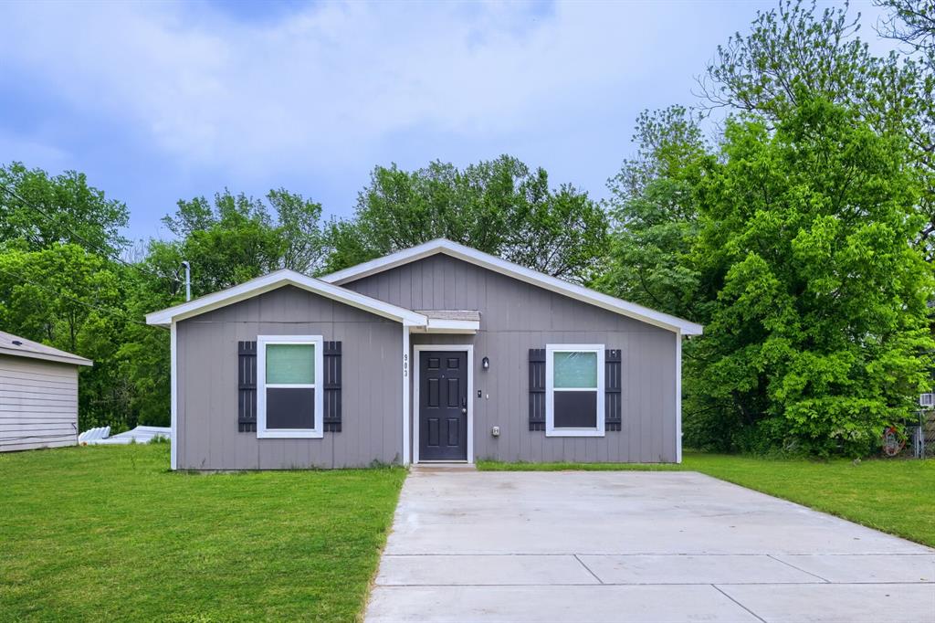 903 Olive Street Waco, TX 76704 - Photo 1 of 15 a view of a yard in front of a house with large trees