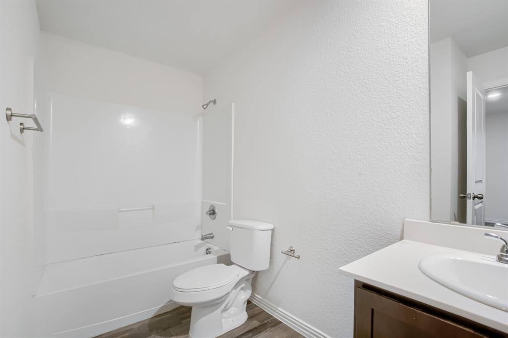903 Olive Street Waco, TX 76704 - Photo 14 of 15 a bathroom with a sink toilet and shower