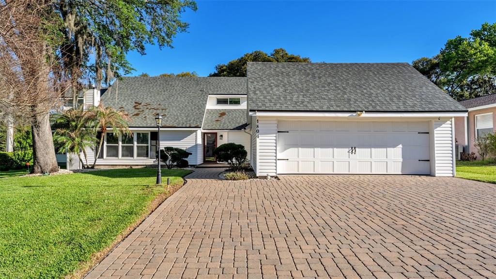 a front view of a house with a garden and yard