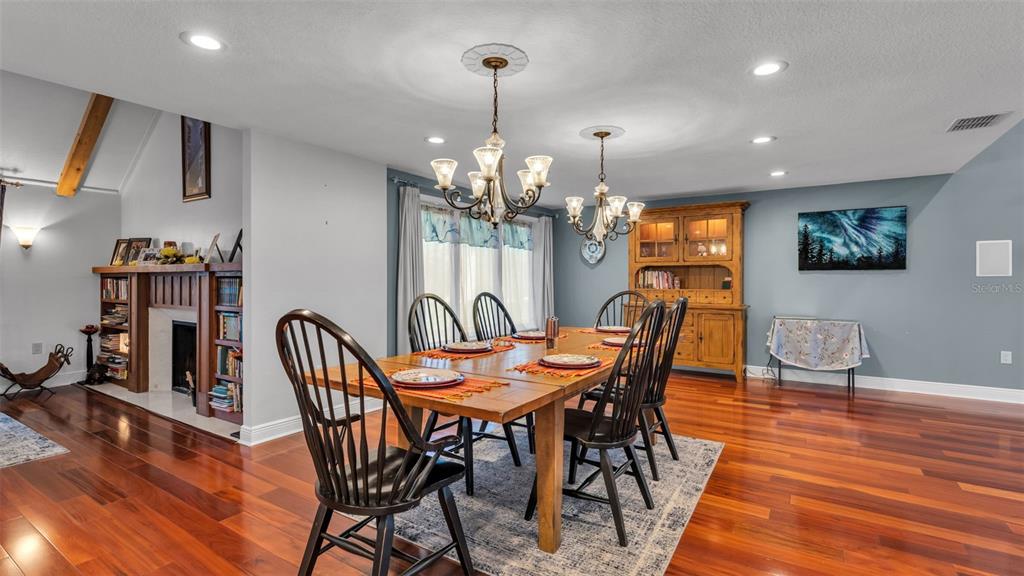 1804 Michelle Lane Lakeland, FL 33813 - Photo 17 of 83 a dining room with furniture a chandelier and wooden floor