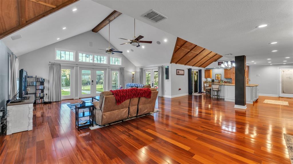 1804 Michelle Lane Lakeland, FL 33813 - Photo 21 of 83 a living room with furniture a wooden floor and a chandelier