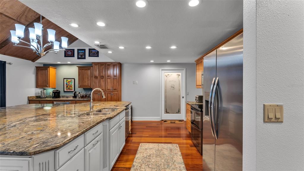 1804 Michelle Lane Lakeland, FL 33813 - Photo 27 of 83 a large kitchen with stainless steel appliances granite countertop a large counter top a refrigerator and a sink