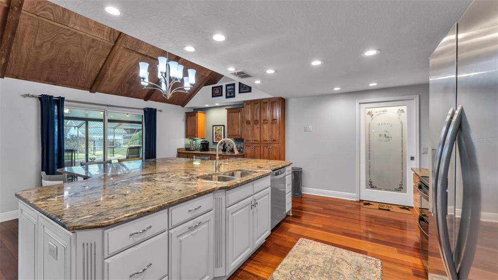 1804 Michelle Lane Lakeland, FL 33813 - Photo 28 of 83 a kitchen with stainless steel appliances granite countertop a sink and a refrigerator