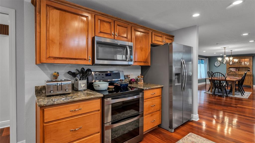 1804 Michelle Lane Lakeland, FL 33813 - Photo 31 of 83 a kitchen with stainless steel appliances granite countertop a stove a refrigerator and a microwave