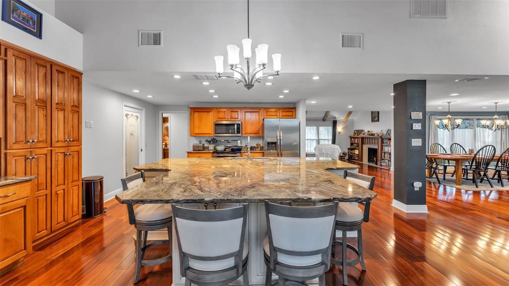 1804 Michelle Lane Lakeland, FL 33813 - Photo 34 of 83 a kitchen with stainless steel appliances granite countertop a kitchen island a stove a table and chairs