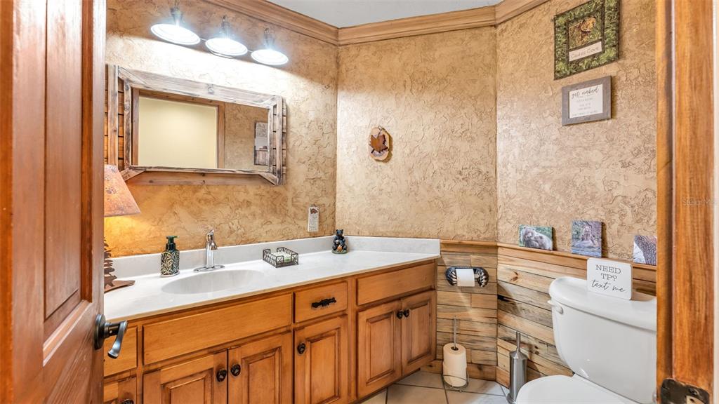 1804 Michelle Lane Lakeland, FL 33813 - Photo 35 of 83 a bathroom with a sink a toilet a mirror and shower