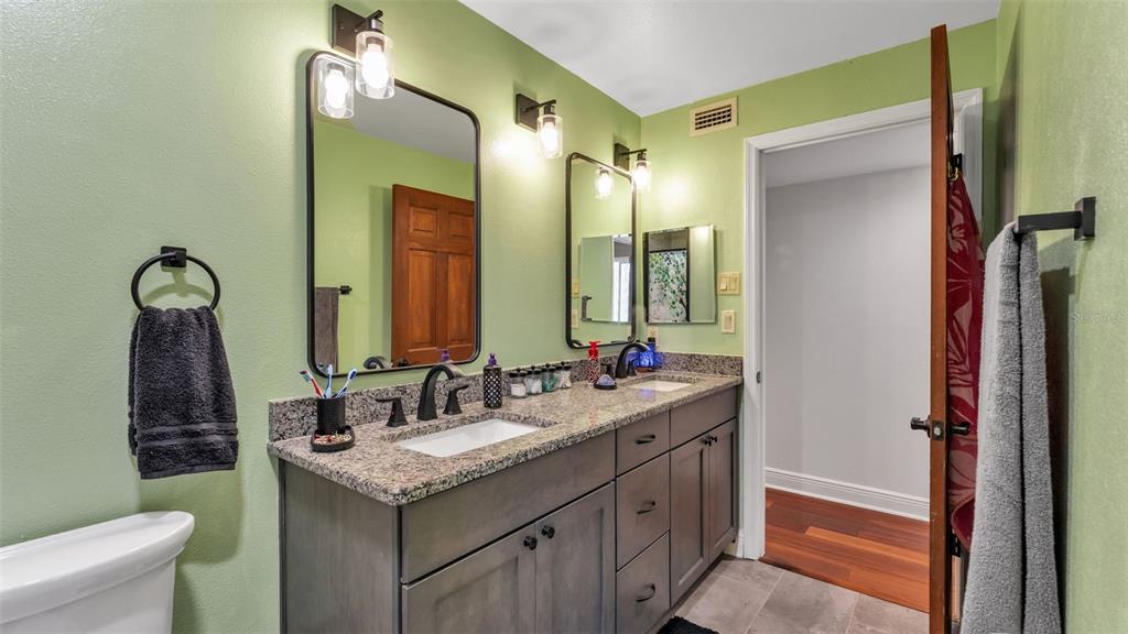 1804 Michelle Lane Lakeland, FL 33813 - Photo 42 of 83 a bathroom with a granite countertop sink and a mirror