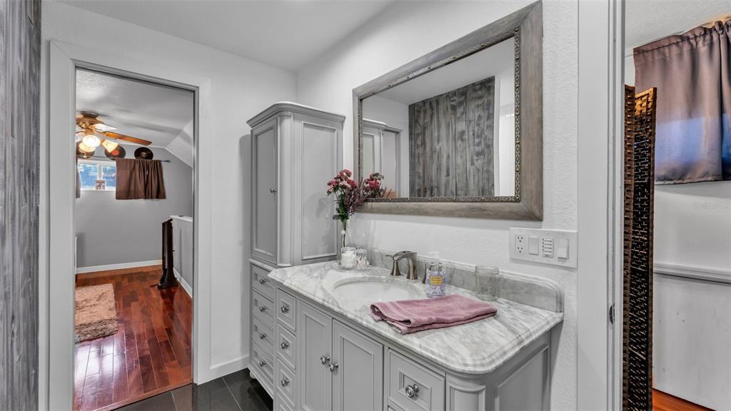 1804 Michelle Lane Lakeland, FL 33813 - Photo 48 of 83 a bathroom with a granite countertop sink and a mirror