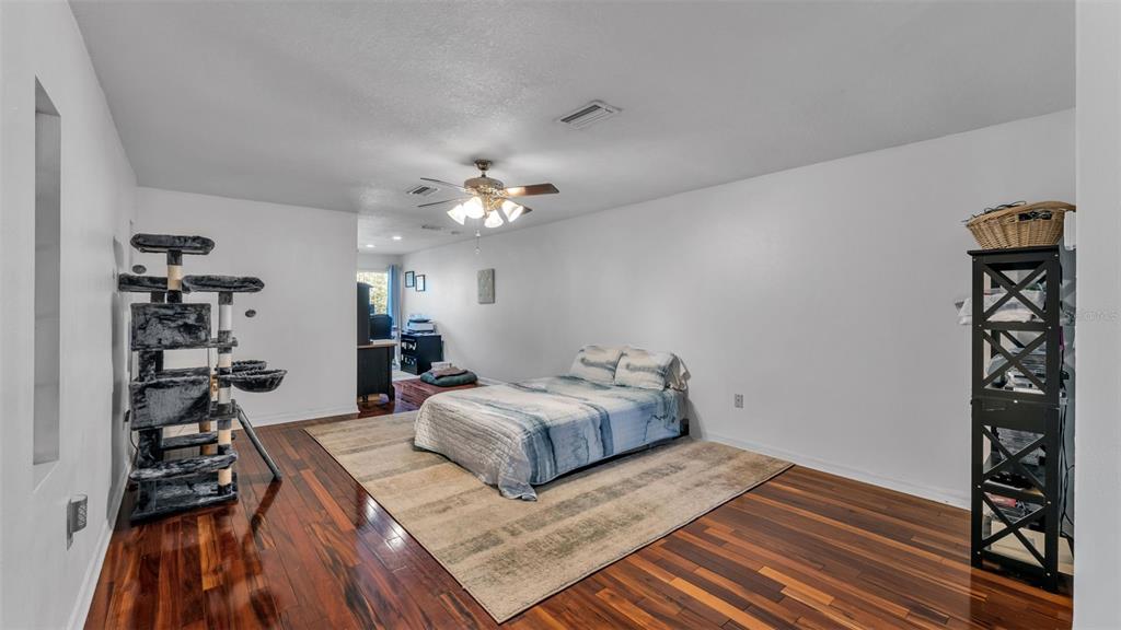 1804 Michelle Lane Lakeland, FL 33813 - Photo 50 of 83 a bedroom with a bed and a chandelier