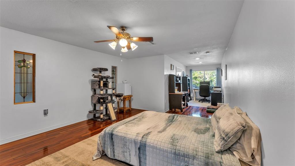 1804 Michelle Lane Lakeland, FL 33813 - Photo 52 of 83 a bed room with a bed mirror and a chair