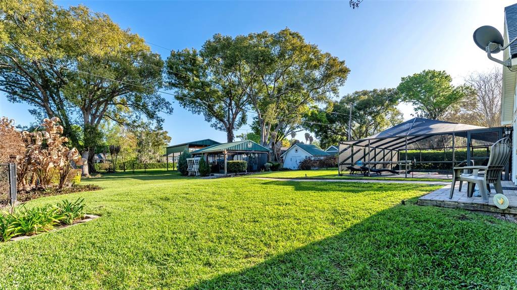 1804 Michelle Lane Lakeland, FL 33813 - Photo 66 of 83 a view of a house with a yard table and chairs under an umbrella