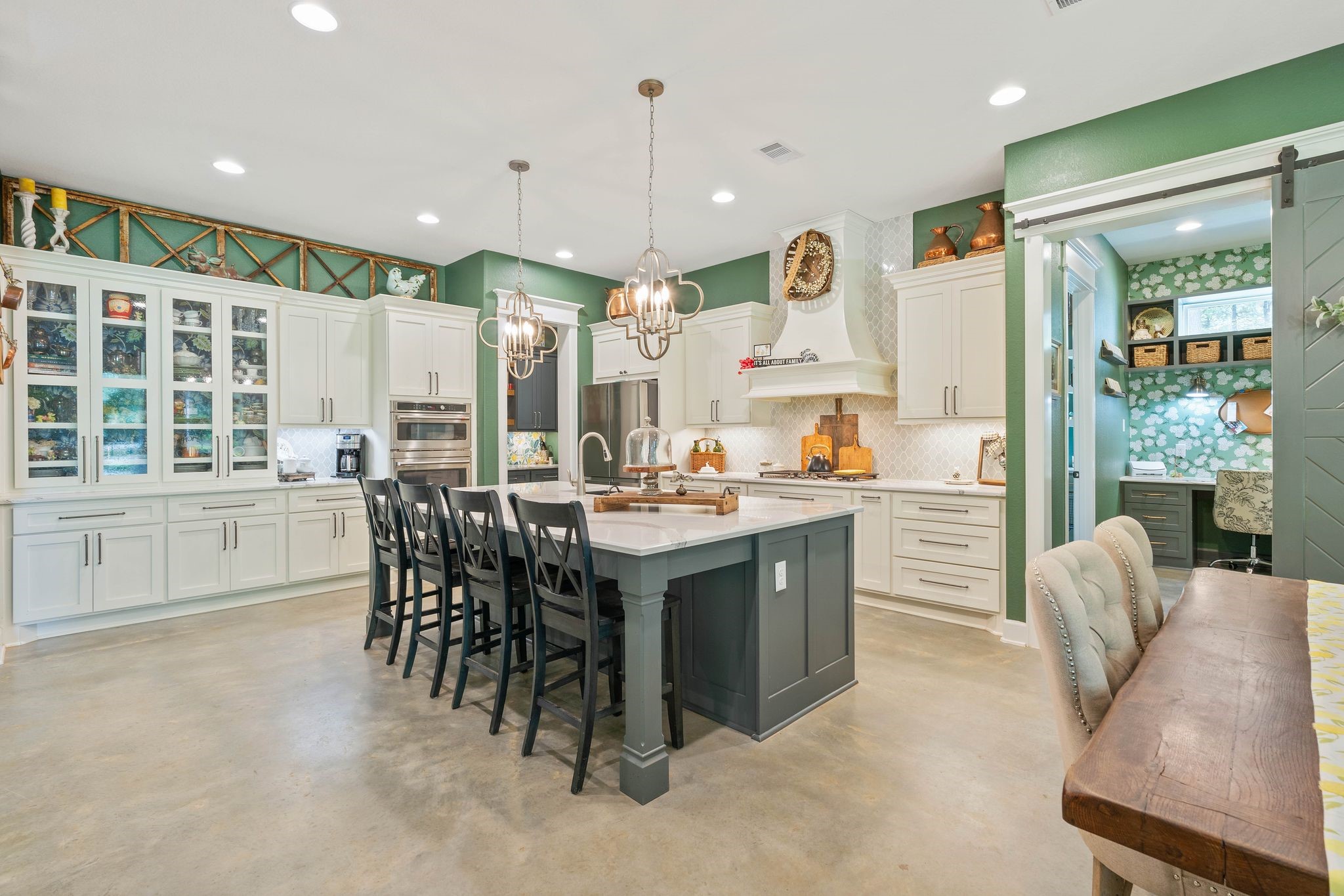 126 Fluorite Court Huntsville, TX 77340 - Photo 12 of 50 a kitchen with stainless steel appliances kitchen island granite countertop a stove a sink a dining table and chairs