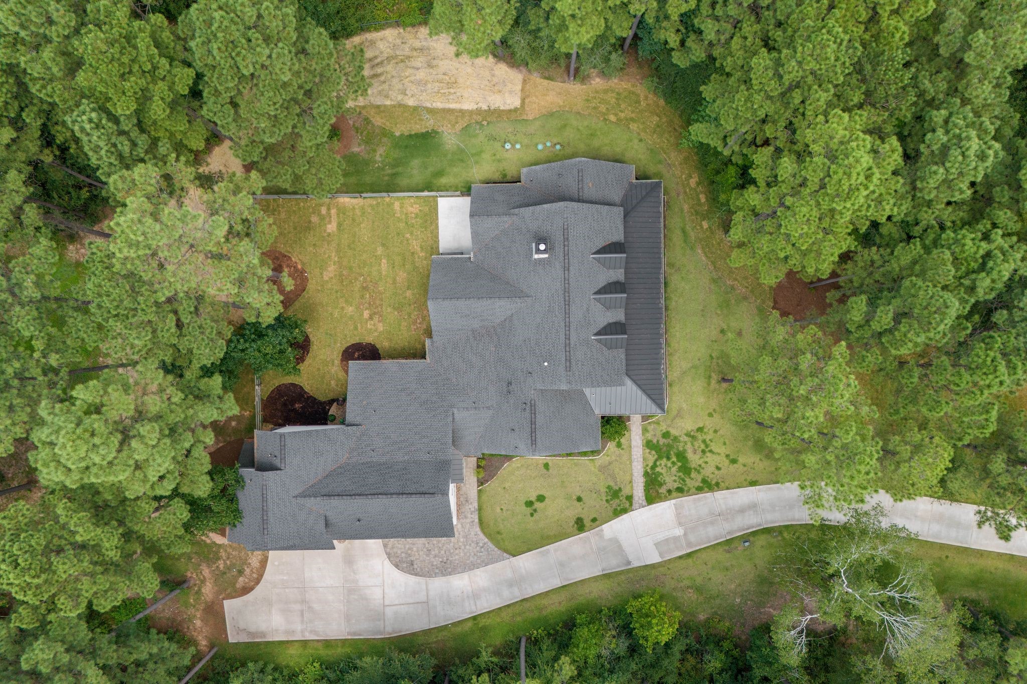126 Fluorite Court Huntsville, TX 77340 - Photo 47 of 50 an aerial view of a house with a garden and trees