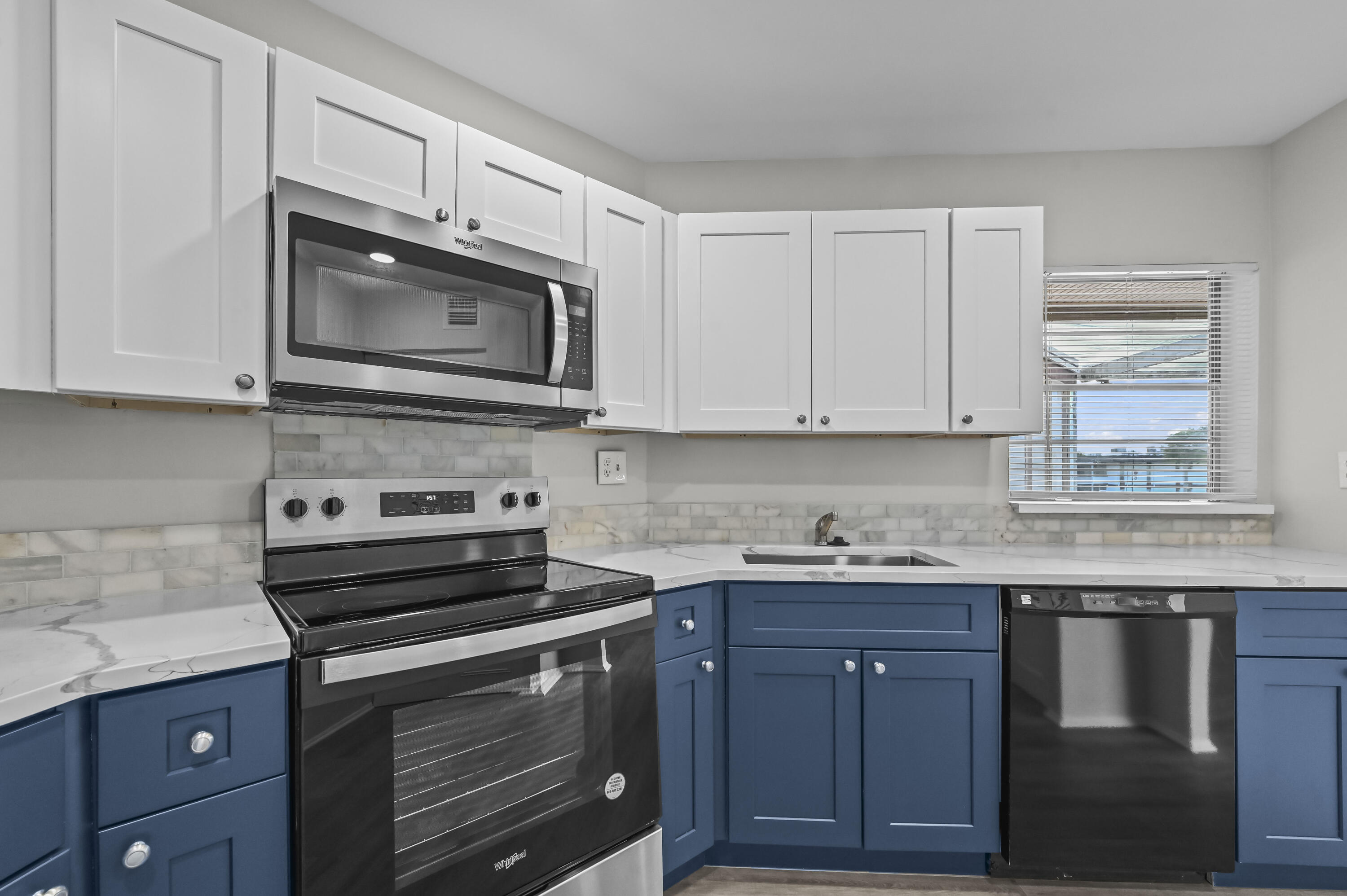 6 Greenway N Royal Palm Beach North, Unit 212 Royal Palm Beach, FL 33411 - Photo 12 of 23 a kitchen with granite countertop cabinets stainless steel appliances and a sink