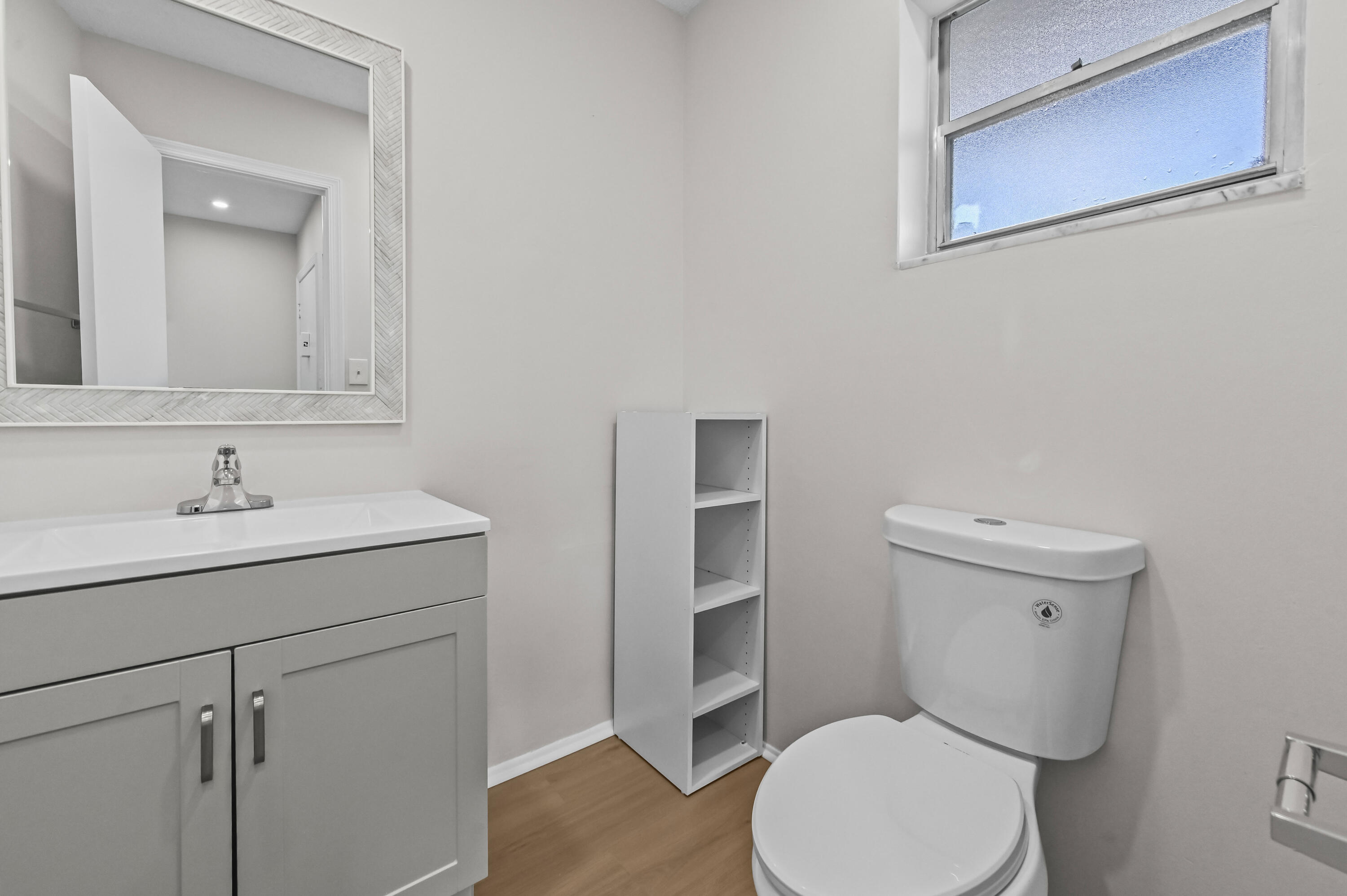 6 Greenway N Royal Palm Beach North, Unit 212 Royal Palm Beach, FL 33411 - Photo 14 of 23 a bathroom with a toilet a sink and mirror