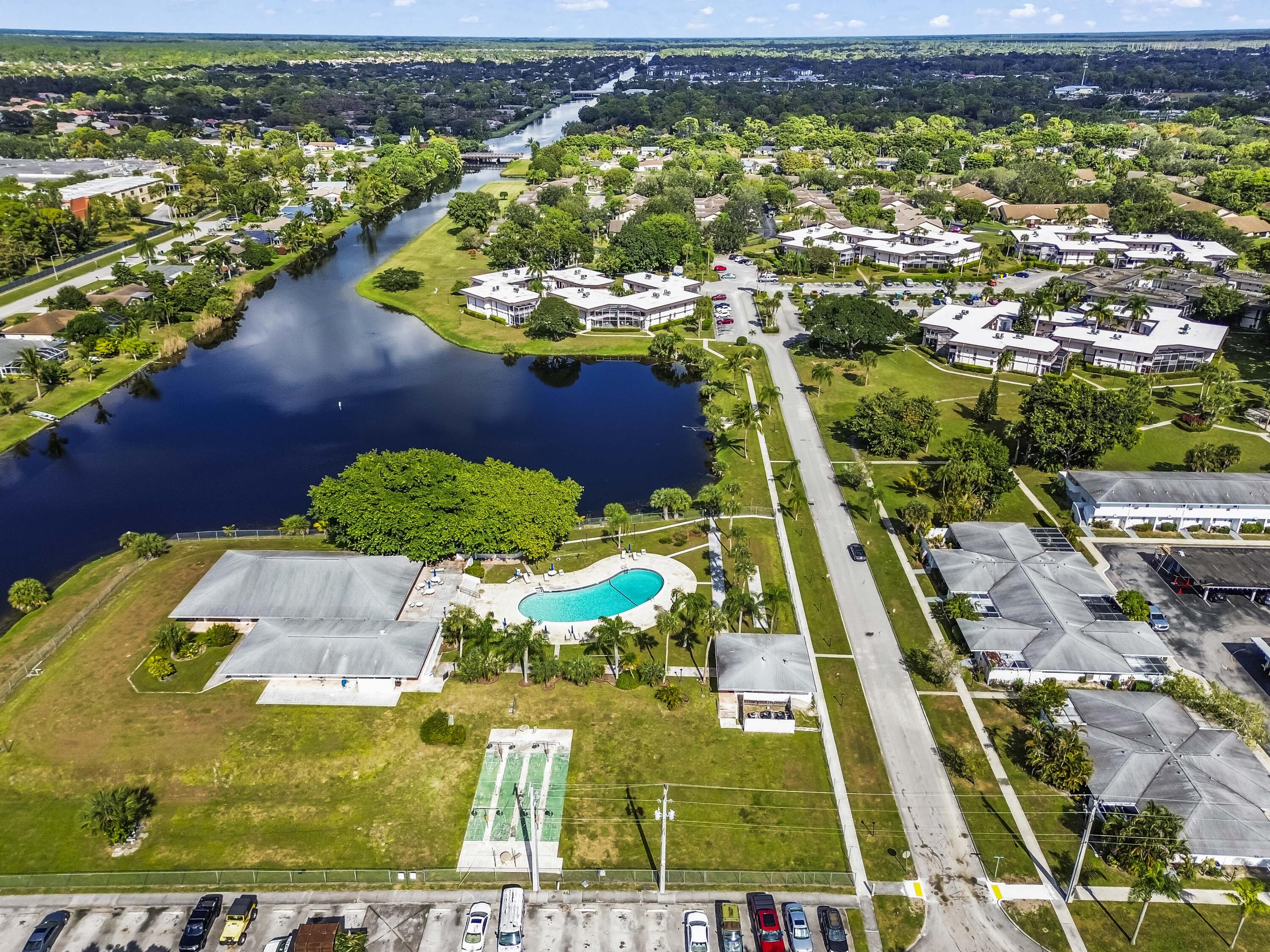6 Greenway N Royal Palm Beach North, Unit 212 Royal Palm Beach, FL 33411 - Photo 17 of 23 an aerial view of residential houses with outdoor space