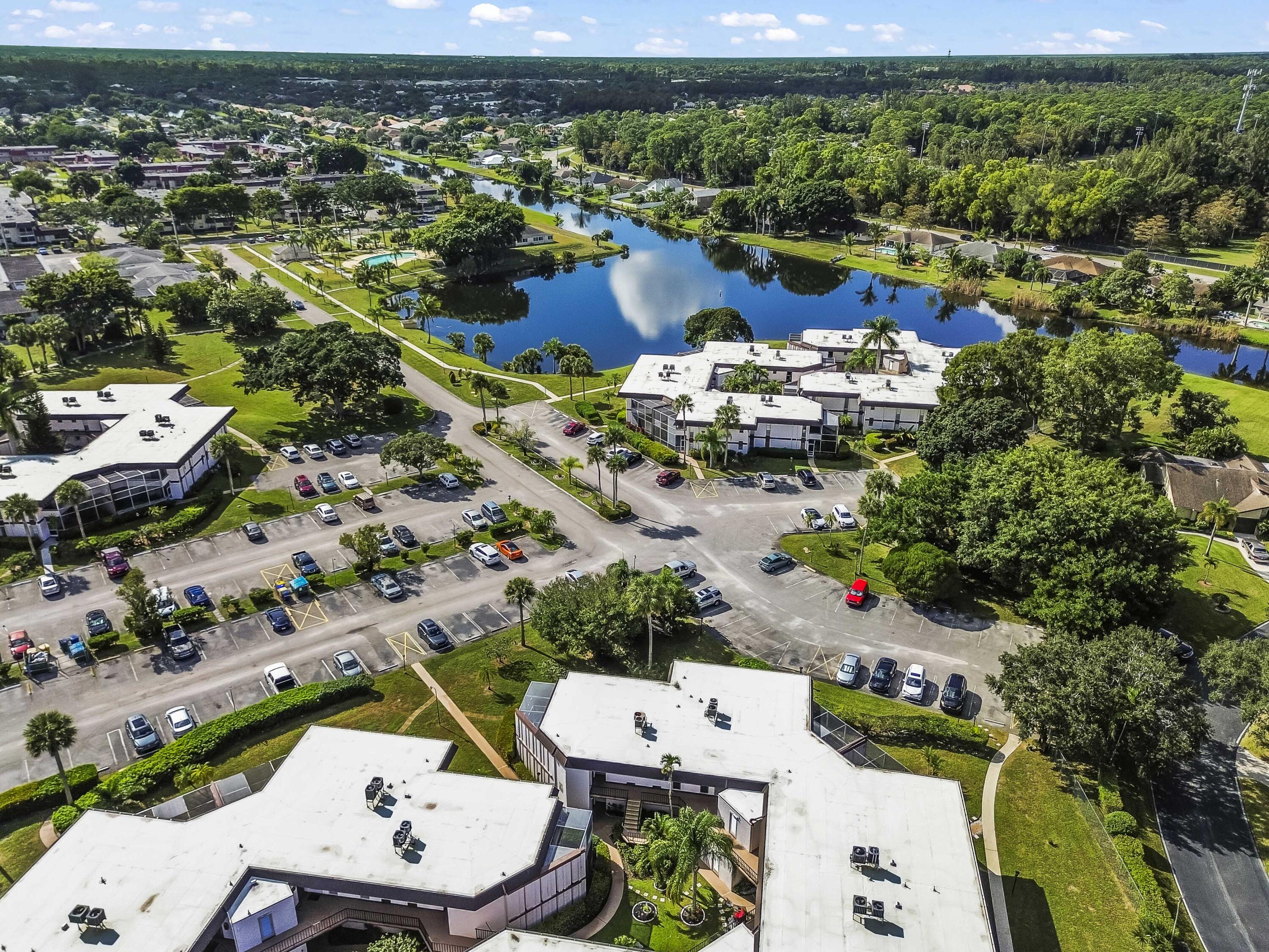 6 Greenway N Royal Palm Beach North, Unit 212 Royal Palm Beach, FL 33411 - Photo 19 of 23 an aerial view of a house with a lake view