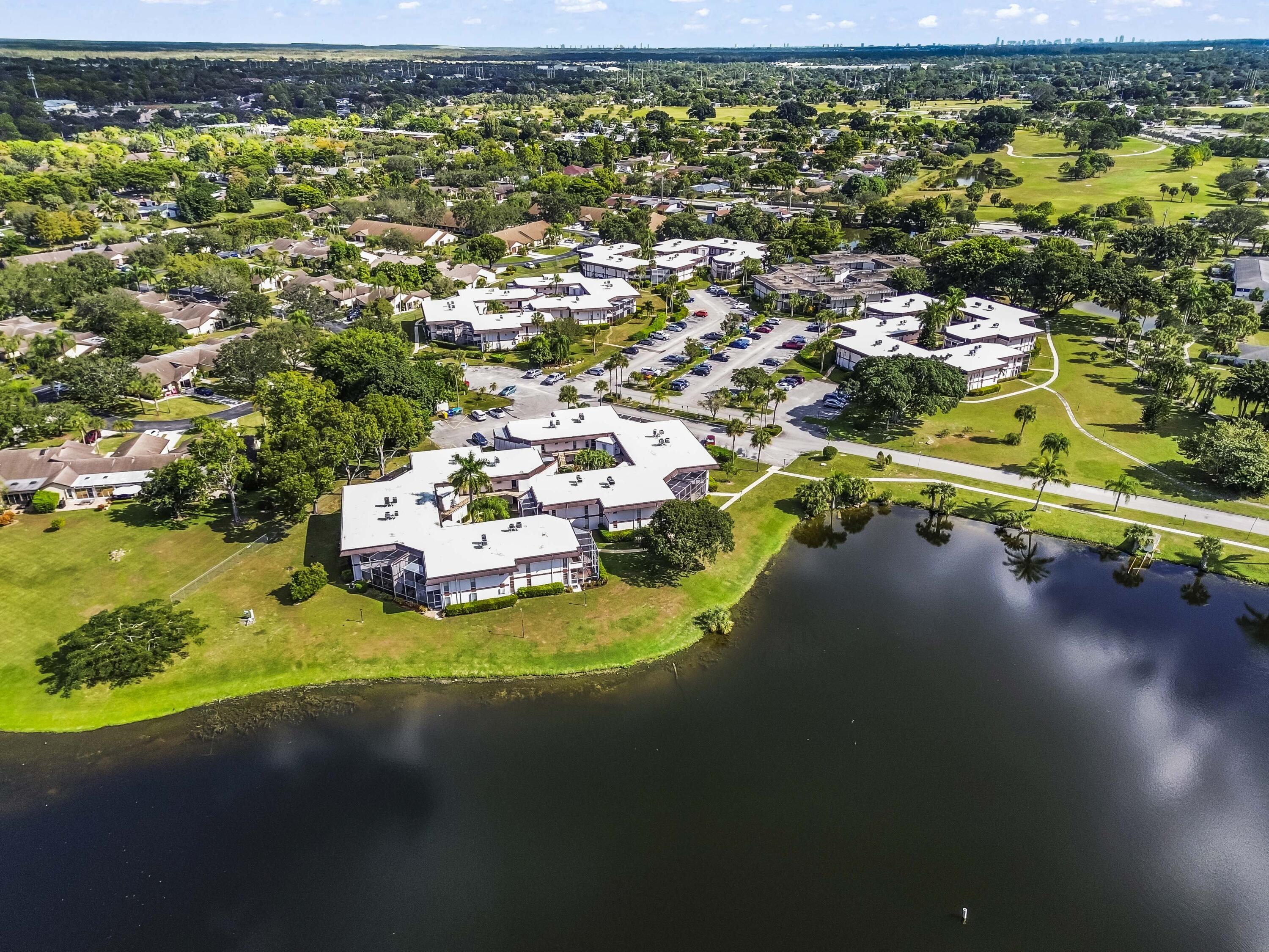 6 Greenway N Royal Palm Beach North, Unit 212 Royal Palm Beach, FL 33411 - Photo 21 of 23 a view of a swimming pool with a yard