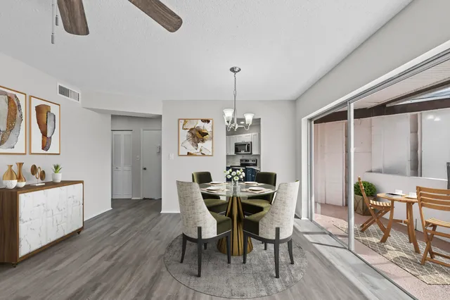 a view of a dining room with furniture and chandelier