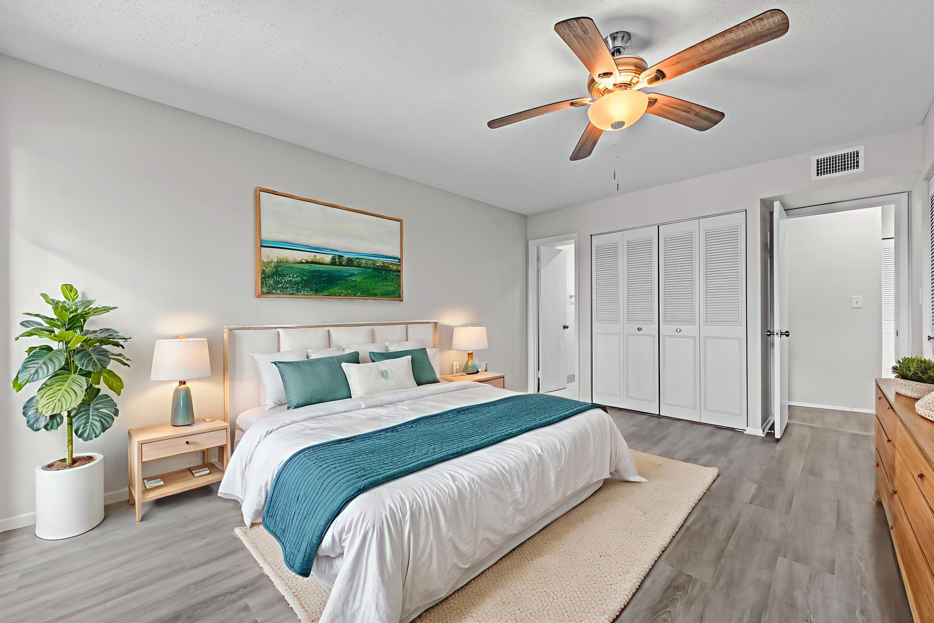 6 Greenway N Royal Palm Beach North, Unit 212 Royal Palm Beach, FL 33411 - Photo 6 of 23 a bedroom with a large bed and a chandelier