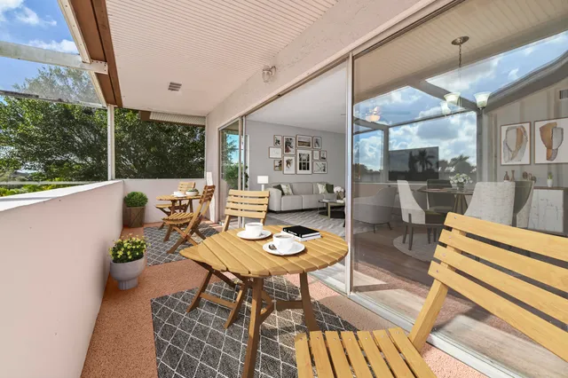 a living room with furniture and a floor to ceiling window